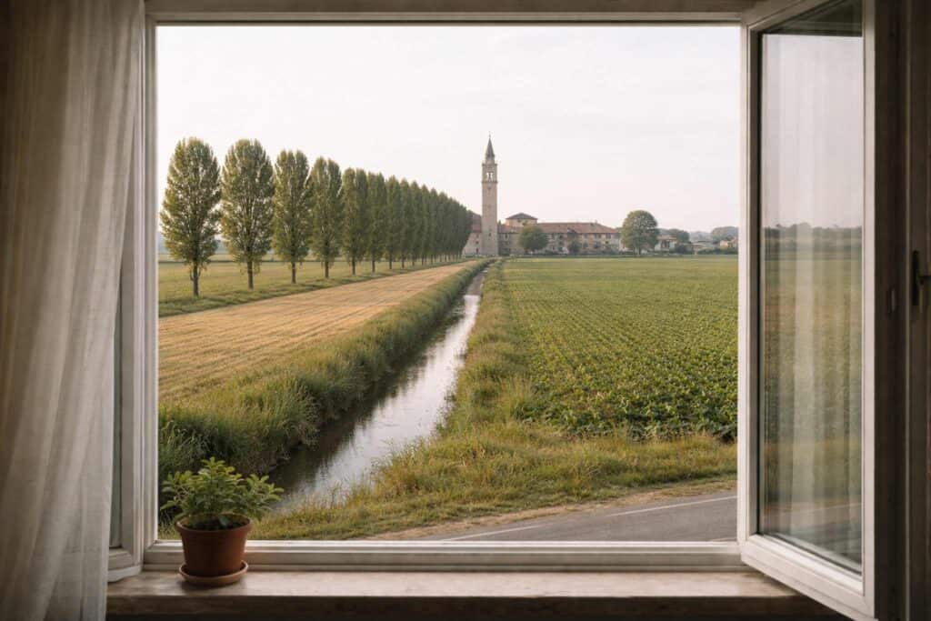 Finestra aperta con vista su campagna italiana e filare di alberi in pianura